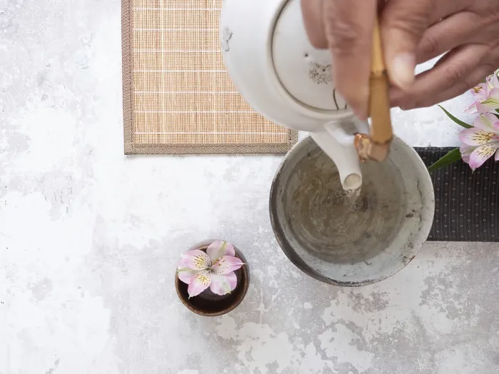 Framed Print : Hands gracefully pouring tea from a white teapot into a ceramic bowl Framed Print : Hands gracefully pouring tea from a white teapot into a ceramic bowl