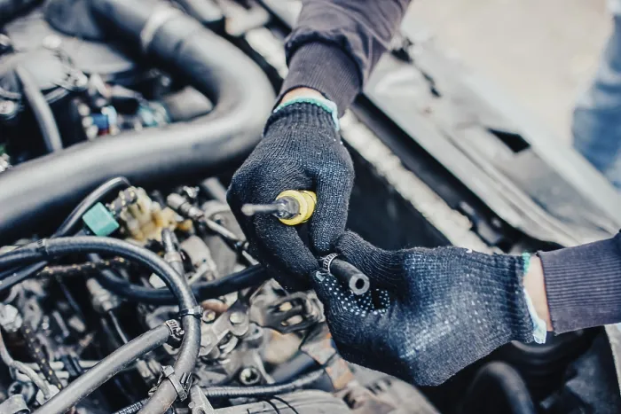Framed Print : Hands repairing an engine with a tool