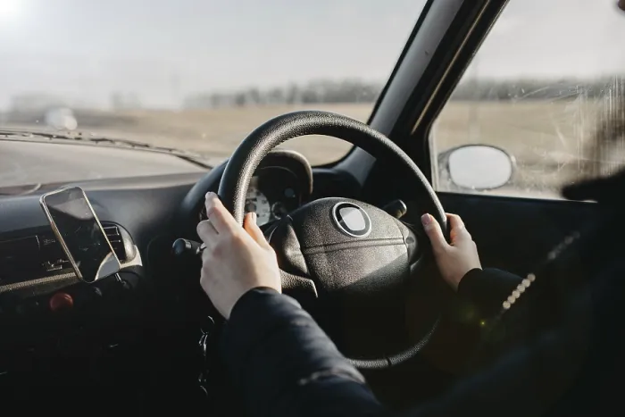 Framed Print : Hands on a steering wheel with sunlight illuminating the interior during a drive Framed Print : Hands on a steering wheel with sunlight illuminating the interior during a drive