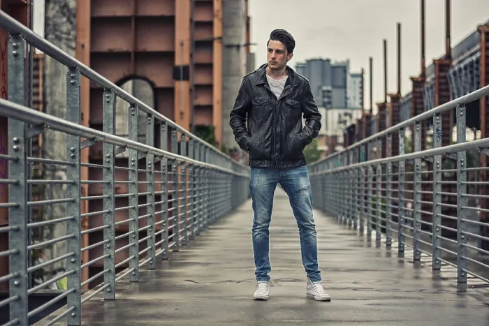 Framed Print : Handsome young man standing outdoors in urban environment on metal stairs