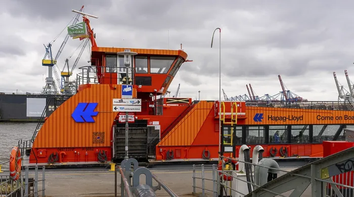 Framed Print : Hapag Lloyd ferry in orange, hvv ferry station at Dockland
