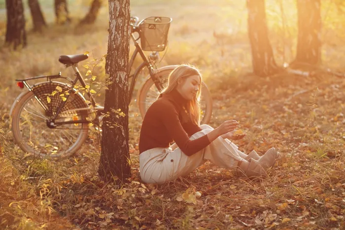 Framed Print : Happy active young woman riding vintage bicycle in autumn park at sunset Framed Print : Happy active young woman riding vintage bicycle in autumn park at sunset