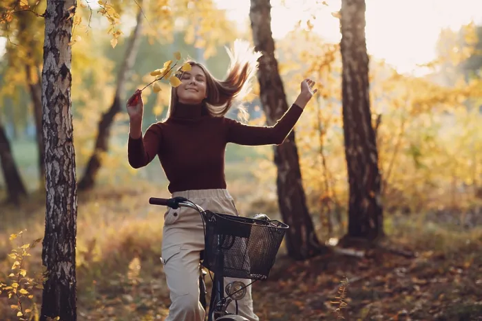 Framed Print : Happy active young woman riding vintage bicycle in autumn park at sunset Framed Print : Happy active young woman riding vintage bicycle in autumn park at sunset