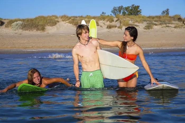 Framed Print : Happy beautiful teen surfers talking on beach shore smiling