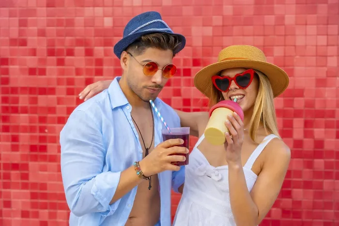 Framed Print : Happy couple enjoying colorful beverages on a summer day