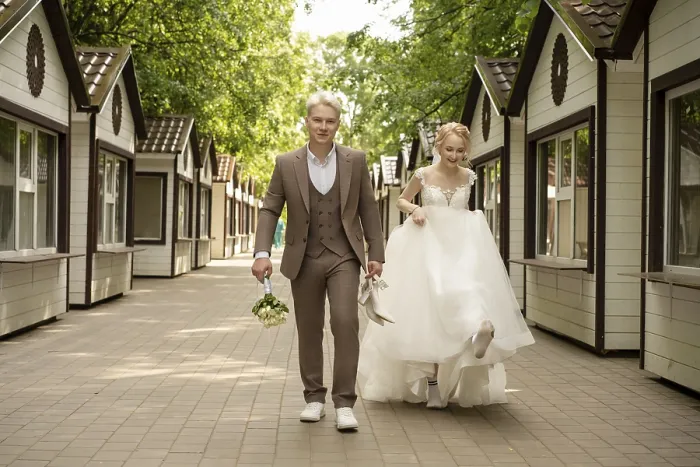 Framed Print : Happy couple strolls hand in hand in a charming outdoor setting surrounded by quaint structures