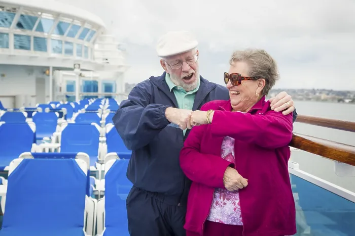 Framed Print : Happy senior couple fist bump on the deck of a luxury passenger cruise ship Framed Print : Happy senior couple fist bump on the deck of a luxury passenger cruise ship