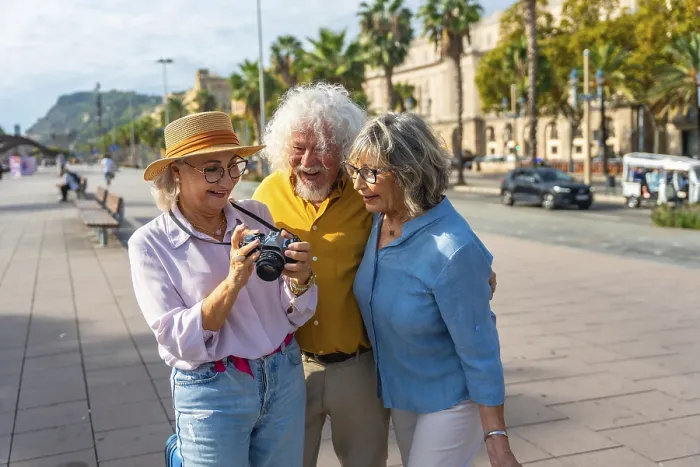 Framed Print : Three happy senior friends are standing on a city street Framed Print : Three happy senior friends are standing on a city street