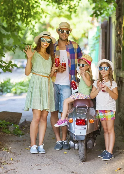 Framed Print : Happy young family near the vintage scooter in the street wearing hats and sunglasses Framed Print : Happy young family near the vintage scooter in the street wearing hats and sunglasses