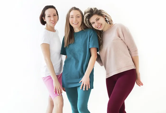 Framed Print : Happy young women smiling after meditating against white wall during yoga session