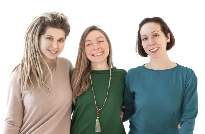 Framed Print : Happy young women smiling after meditating against white wall during yoga session