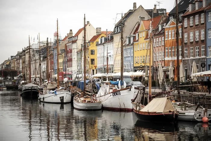 Framed Print : Harbor scene with boats lined up beside vibrant buildings and reflections in the water in Nyhavn Framed Print : Harbor scene with boats lined up beside vibrant buildings and reflections in the water in Nyhavn