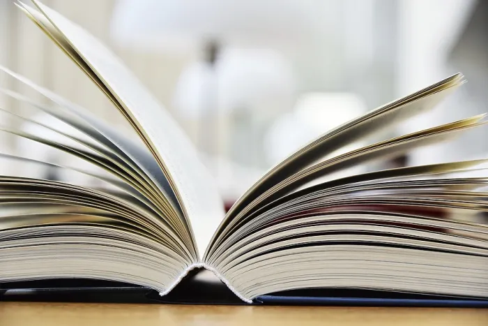 Framed Print : Hardcover book lying on the table in a library