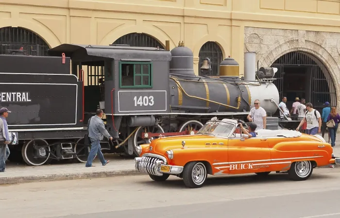 Framed Print : Havana Cuba february 2012 a typical Cuban cabriolet passes in front of the old steam train on display near the harbor Framed Print : Havana Cuba february 2012 a typical Cuban cabriolet passes in front of the old steam train on display near the harbor