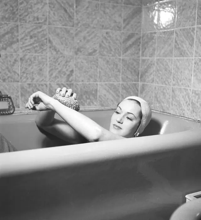 Framed Print : Having a bath 1940. Actress Eivor Landstroem, 1919-2004, pictured here at home, having a bath. She is wearing a protective cap to prevent her hair from becoming wet. She uses a bath sponge in the bath. Sweden August 1940 Framed Print : Having a bath 1940. Actress Eivor Landstroem, 1919-2004, pictured here at home, having a bath. She is wearing a protective cap to prevent her hair from becoming wet. She uses a bath sponge in the bath. Sweden August 1940
