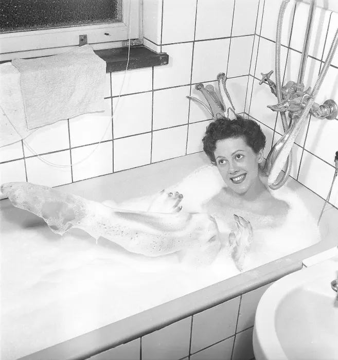 Framed Print : Having a bath 1950. A young smiling woman wearing a princess crown