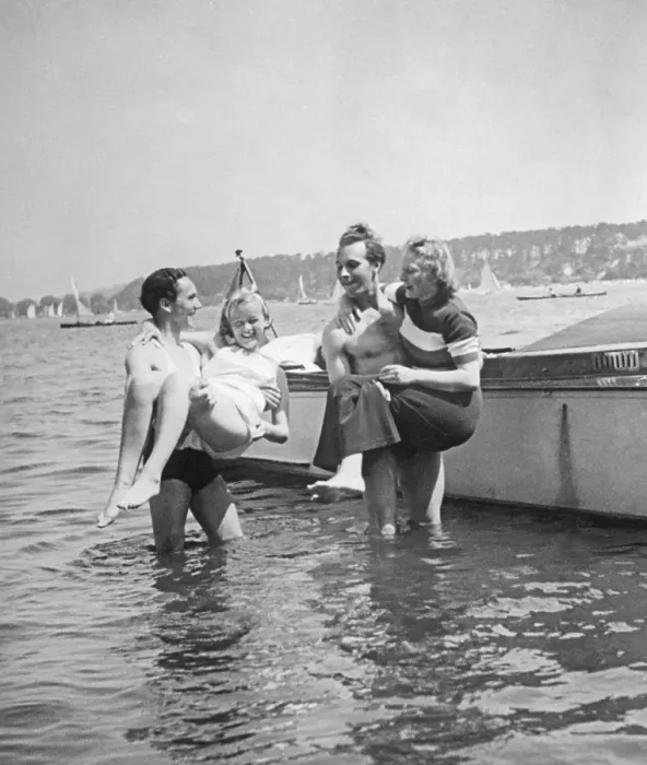 Framed Print : Having fun in the 1930s. A pair of strong men have lifted ut their girlfriends in their arms and are holding them above the water. Sweden 1930s