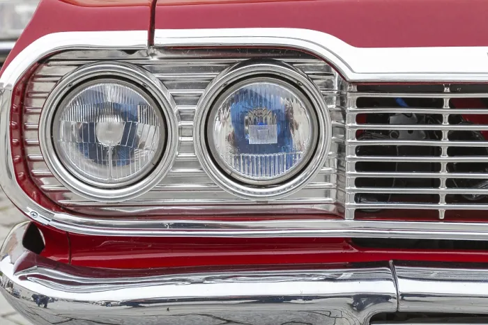 Framed Print : Headlights and radiator grille of an American saloon car from the sixties