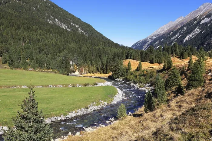Framed Print : Headwaters of waterfalls - the narrow fast river among green mountain meadows