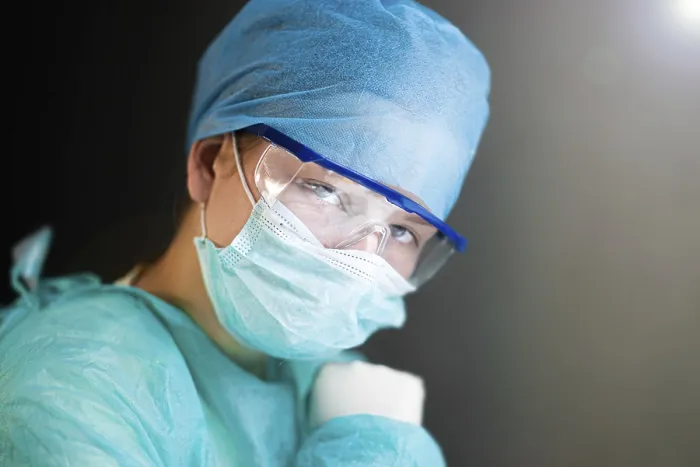 Framed Print : A healthcare worker in safety gear looking determinedly ahead
