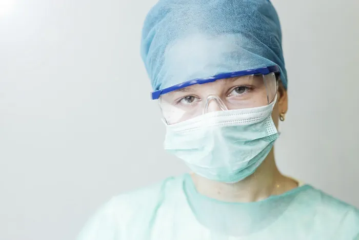 Framed Print : A healthcare worker wearing protective gear