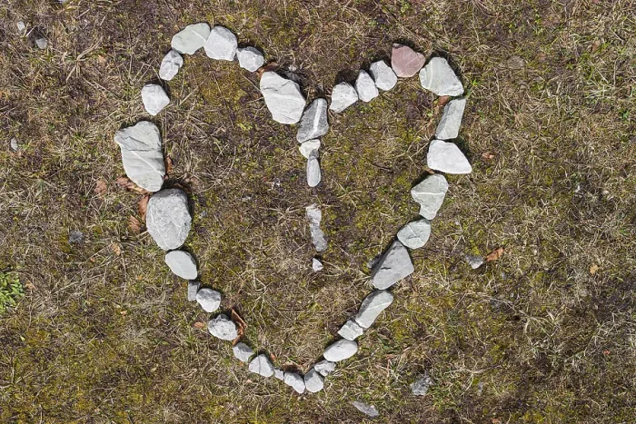 Framed Print : Heart of stone. Pebbles arranged as a heart symbol