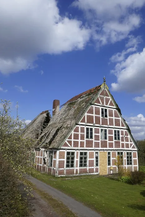 Framed Print : Heavily damaged thatched roof of a half-timbered house