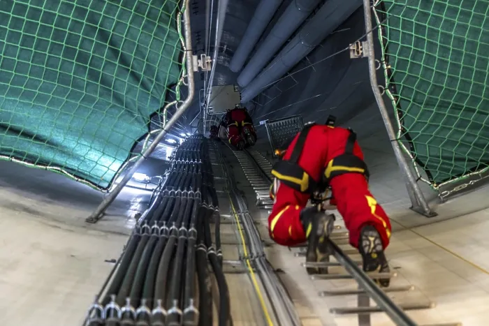 Framed Print : Height rescuers from the Oberhausen professional fire brigade practise abseiling from a wind turbine from a height of