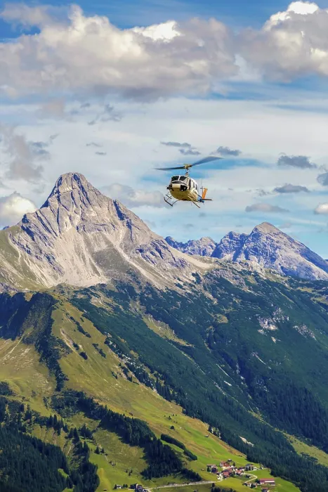 Framed Print : A helicopter flies over a mountainous region under a cloudy sky Framed Print : A helicopter flies over a mountainous region under a cloudy sky