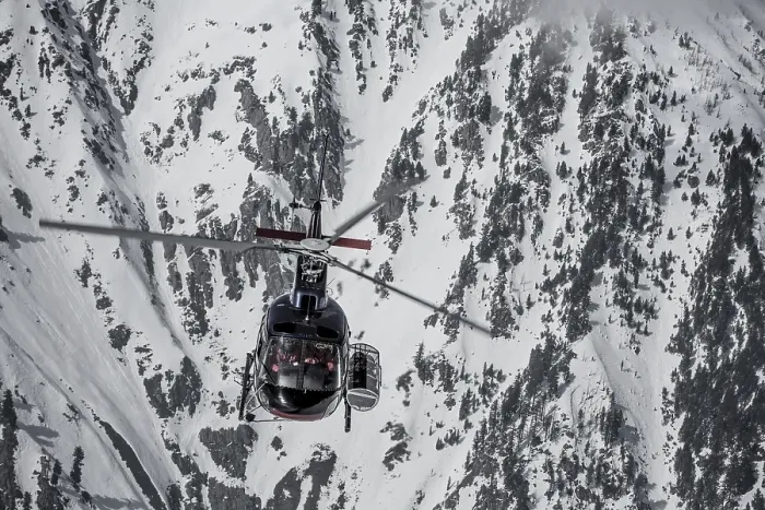 Framed Print : Helicopter in front of snow-covered rock face