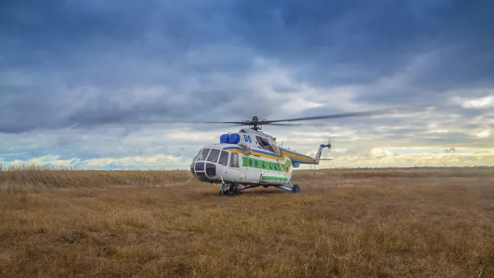Framed Print : Helicopter taking off in a field against a beautiful sky