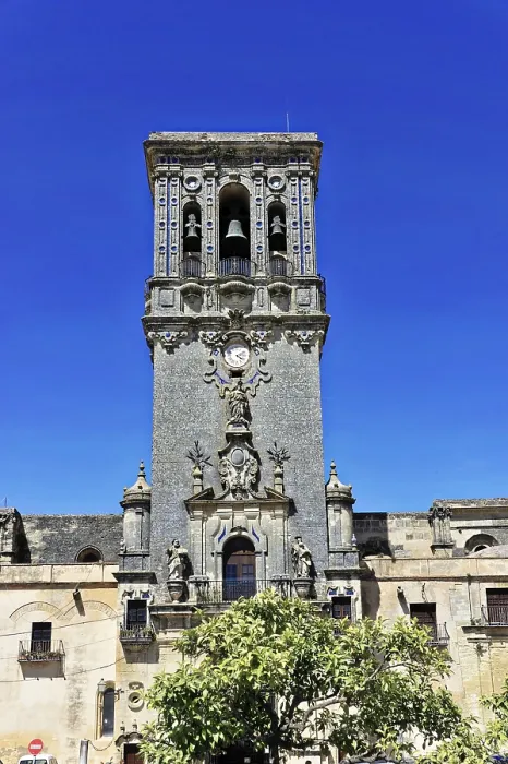 Framed Print : High stone tower with decorative reliefs and blue sky in the background