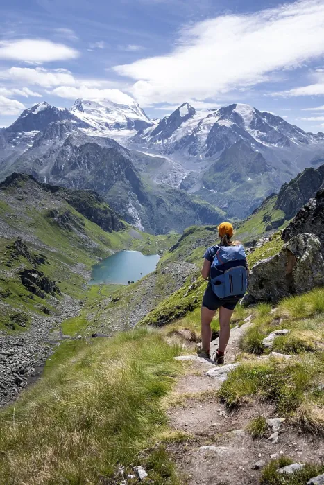 Framed Print : Hiker on hiking trail, mountain lake Lac de Louvie with glaciated summit of the Grand Combin