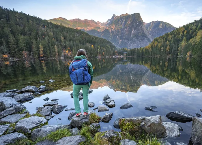 Framed Print : Hiker at the lake, mountain peaks of the Oetztal Alps are reflected in Lake Piburger See