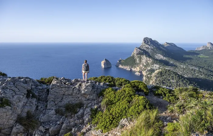 Framed Print : Hiker looking over rocky cliffs and sea