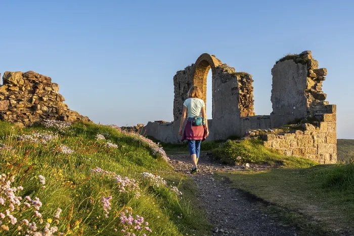 Framed Print : A hiker on a path in the ruins of Botallack Mine