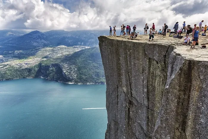 Framed Print : Hiker on rocky peak Preikestolen