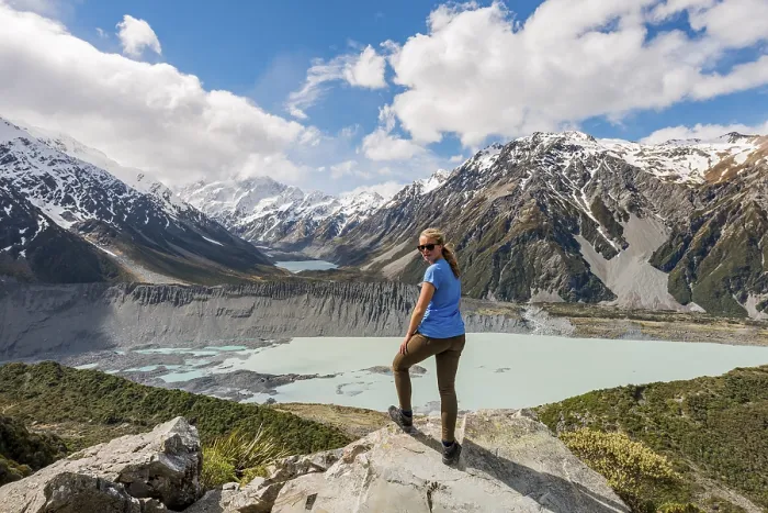 Framed Print : Hiker standing on rocks, view into the Hooker Valley from Sealy Tarns Track