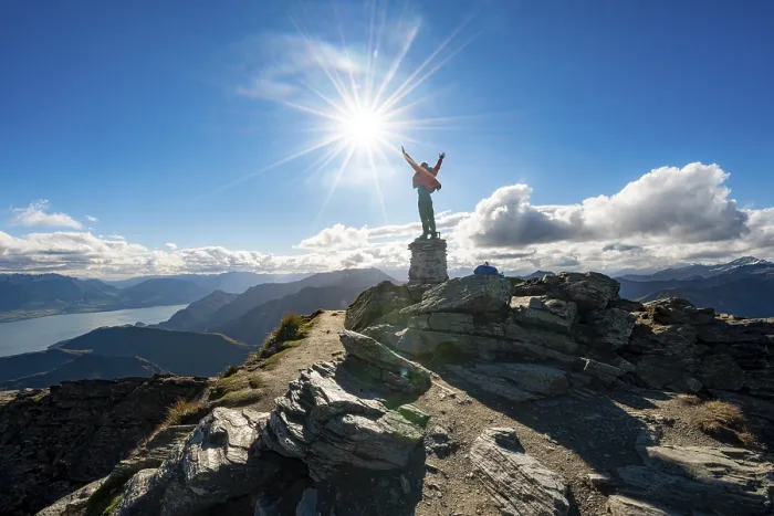 Framed Print : Hiker stretches out his arms in the air