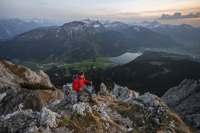 Framed Print : Hiker at the summit of Schartschrofen at sunset