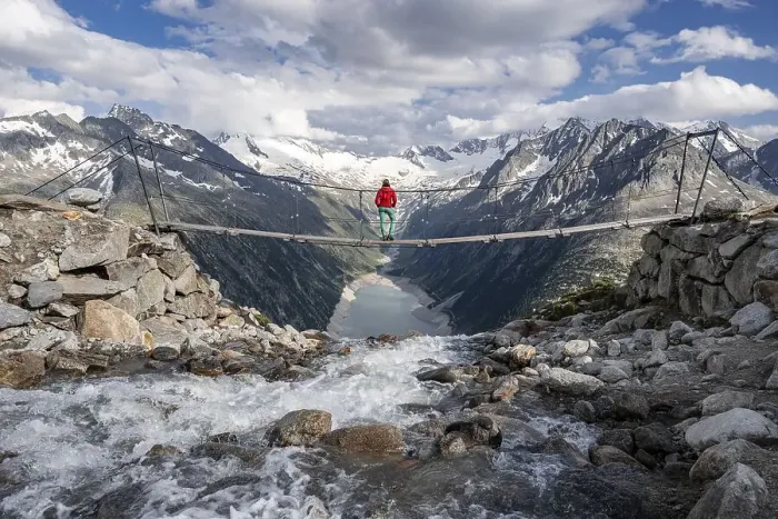 Framed Print : Hiker, woman on suspension bridge at the Olpererhuette