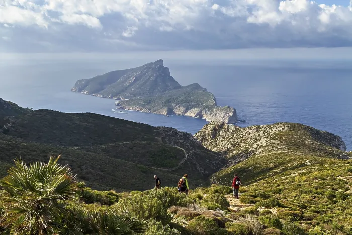 Framed Print : Two hikers on a mountain trail with panoramic views of the sea and surrounding greenery