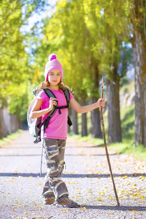 Framed Print : Hiking kid girl with walking stick and backpack exploring autumn track and camouflage pants Framed Print : Hiking kid girl with walking stick and backpack exploring autumn track and camouflage pants