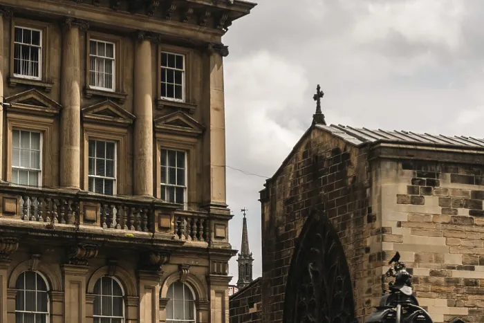 Framed Print : Historic building next to church with intricate stonework under a partly cloudy sky in Newcastle Upon Tyne Framed Print : Historic building next to church with intricate stonework under a partly cloudy sky in Newcastle Upon Tyne