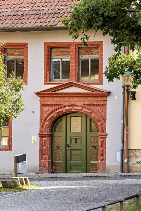 Framed Print : Historic building facade with green door and decorative red stone decorations Framed Print : Historic building facade with green door and decorative red stone decorations