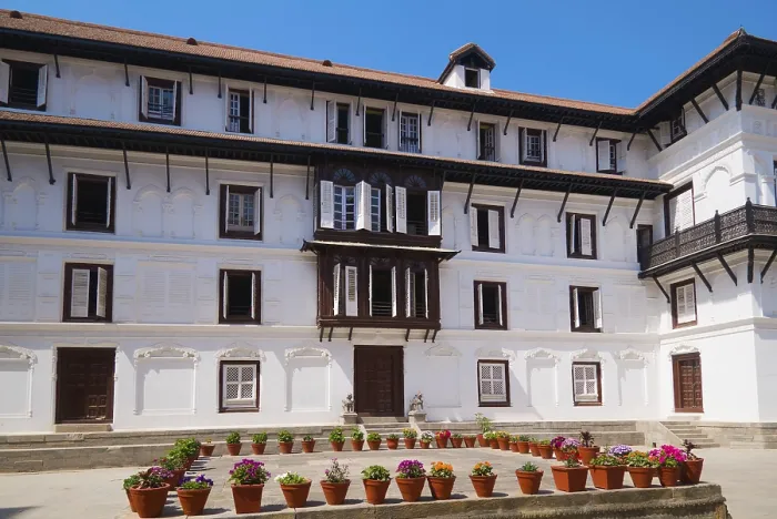 Framed Print : Historic building with numerous windows and decorative flower pots in front