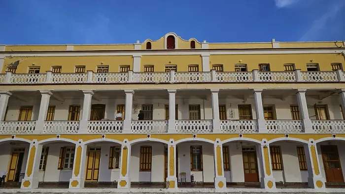 Framed Print : Historic building with yellow facade and balconies against a blue sky Framed Print : Historic building with yellow facade and balconies against a blue sky