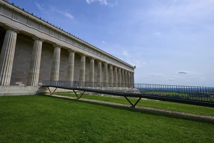 Framed Print : Historic columned building next to a green area under a clear blue sky