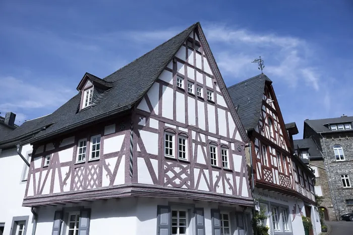 Framed Print : Historic half-timbered house against a clear blue sky in an urban setting Framed Print : Historic half-timbered house against a clear blue sky in an urban setting