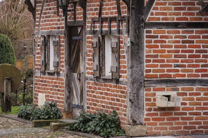 Framed Print : Historic half-timbered house with wooden doors and small windows Framed Print : Historic half-timbered house with wooden doors and small windows